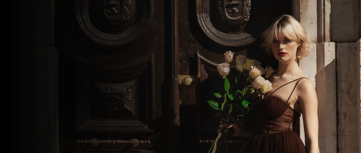 Florista de rosas em Portugal com elegante ramo de rosas premium em tons suaves junto a uma porta clássica.