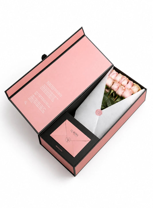 QRoses premium gift box with pink roses, branded wrapping and matching envelope.