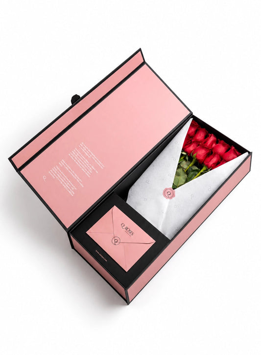 QRoses premium gift box with red roses, branded wrapping and matching envelope.
