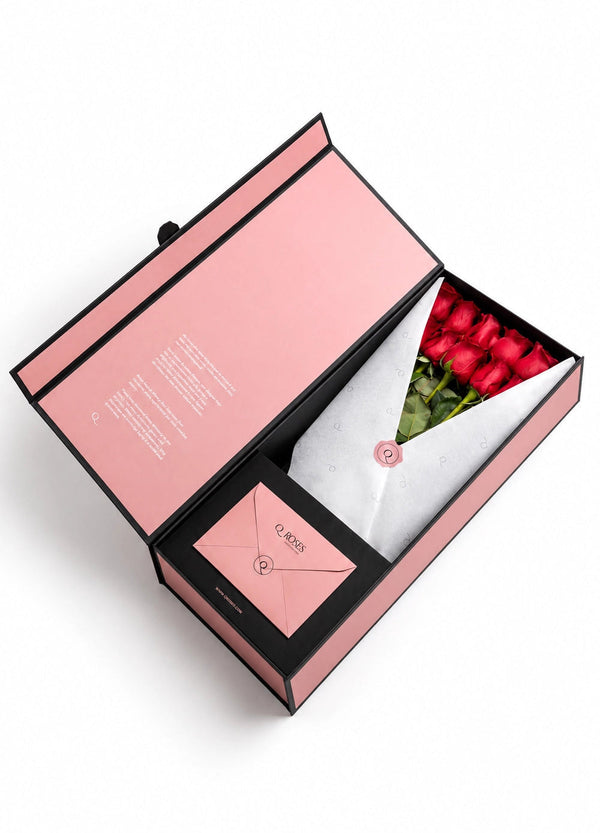 QRoses premium gift box with red roses, branded wrapping and matching envelope.