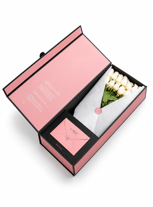 QRoses premium gift box with white roses, branded wrapping and matching envelope.
