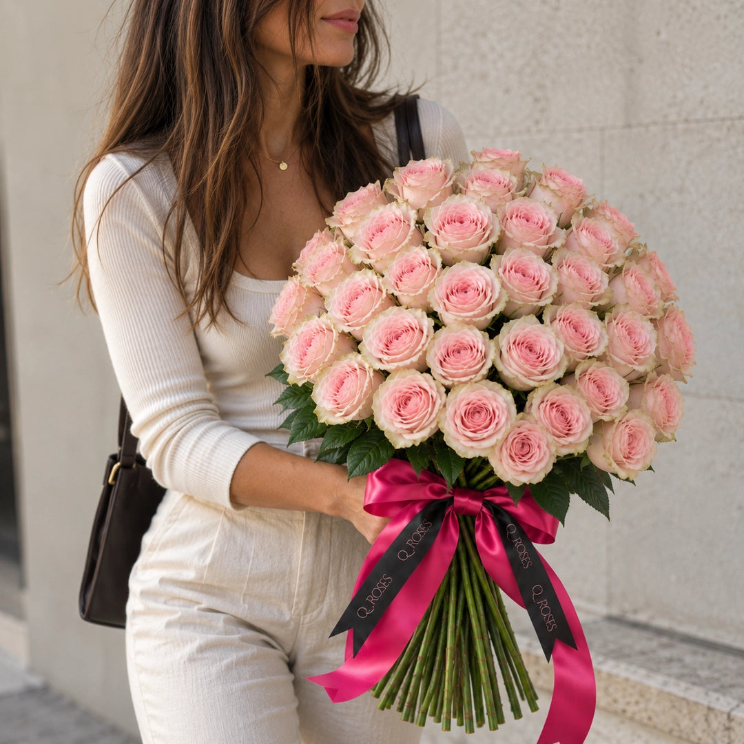 Mulher com Ramo Elegance 50 de rosas cor-de-rosa mostrando as dimensões do ramo